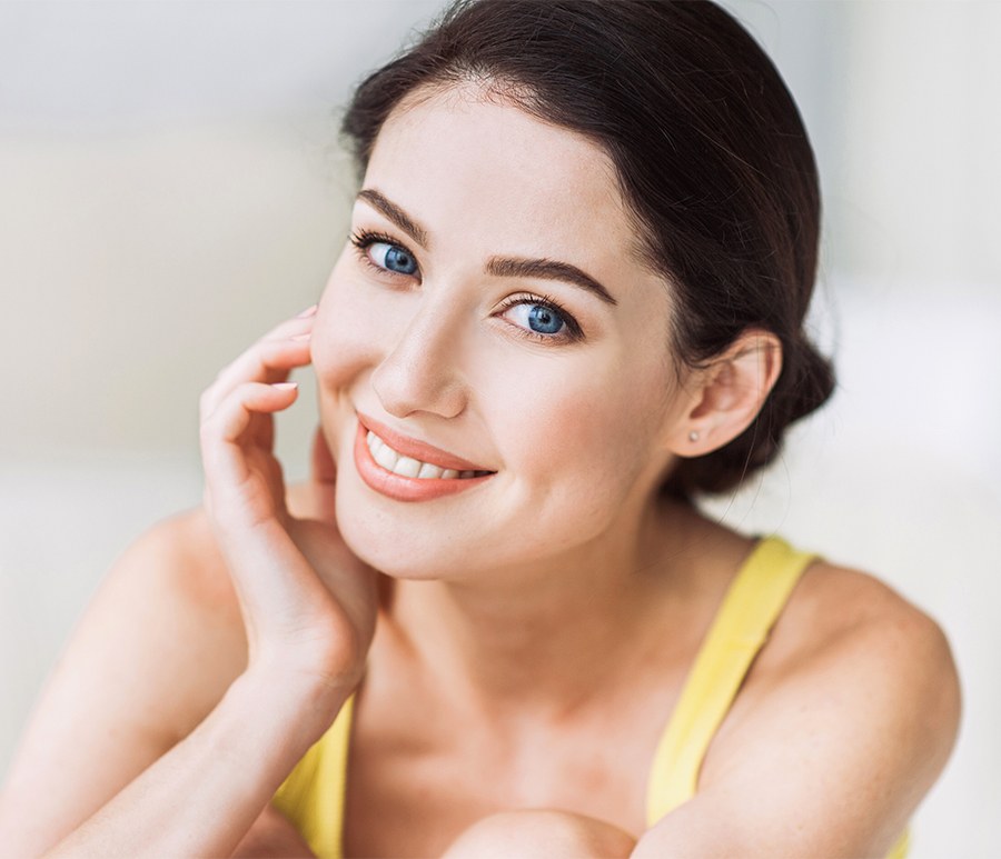 Close-up portrait of beautiful woman feeling side of face